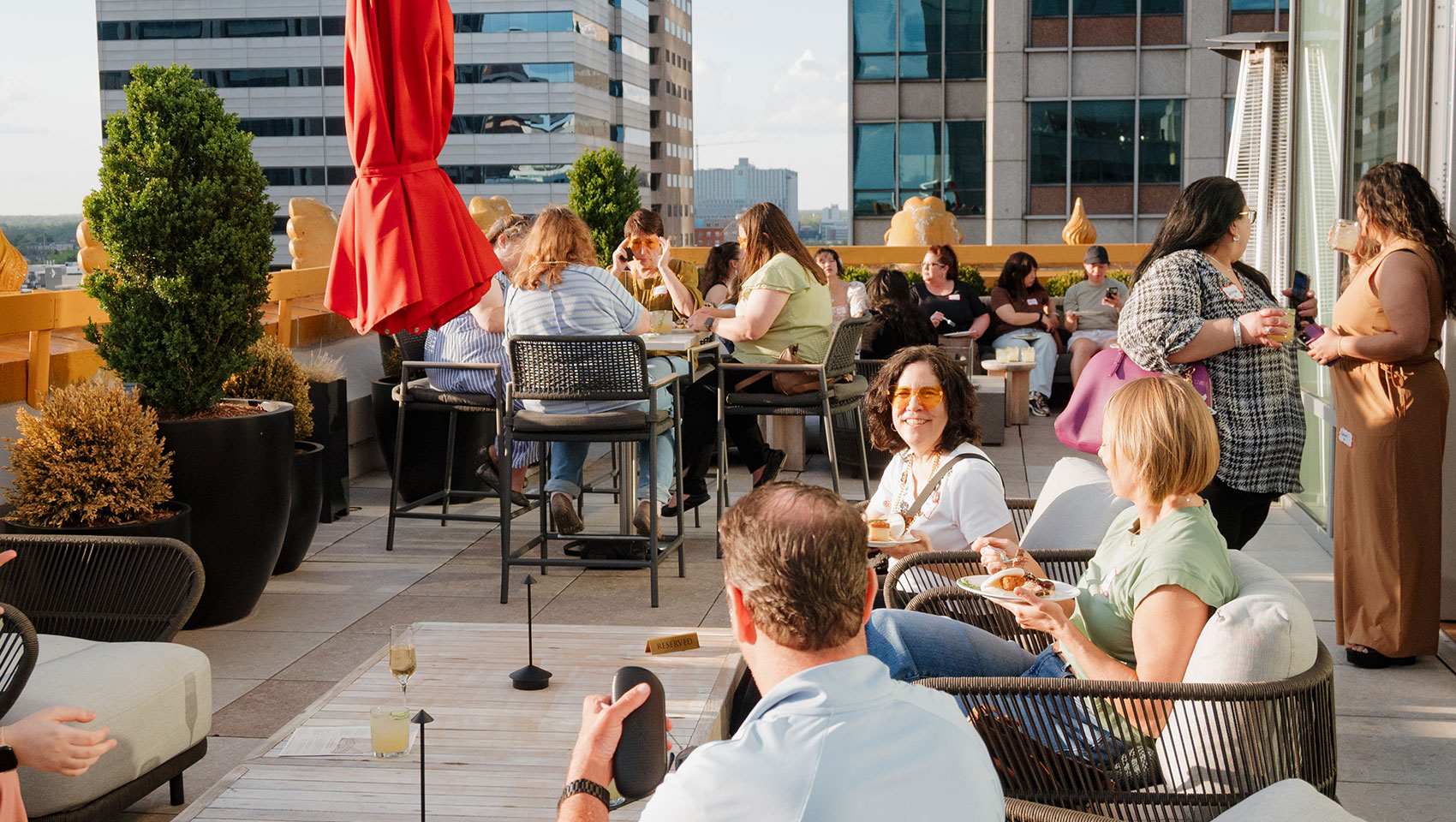people enjoying food at astrea rooftop
