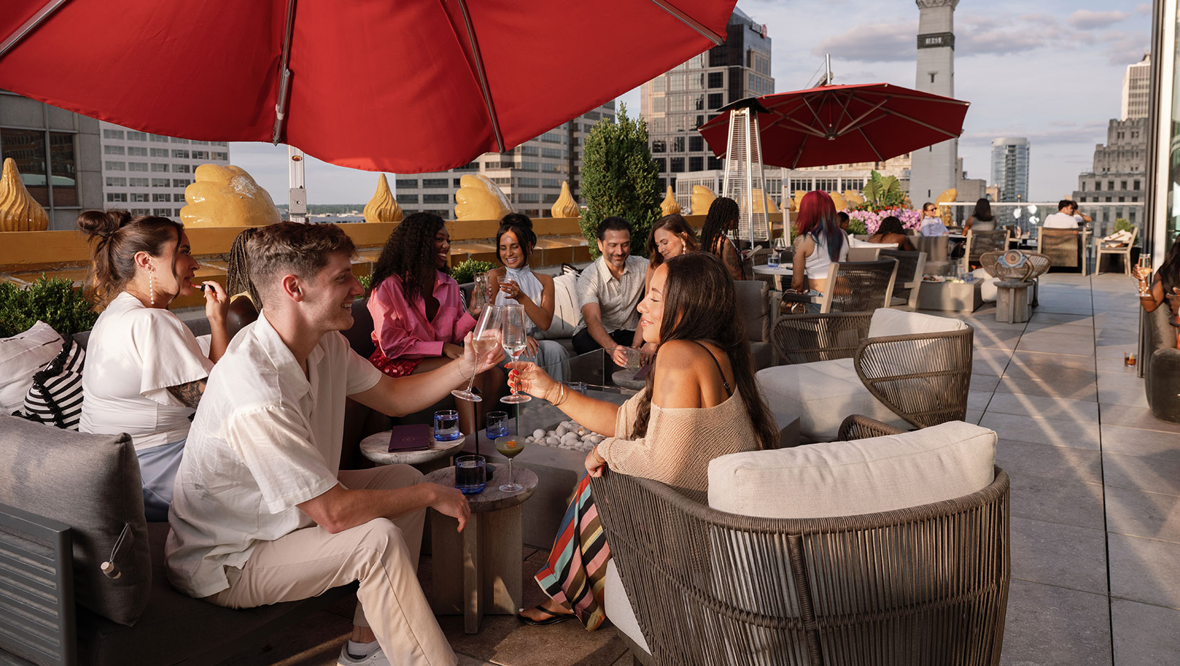people enjoying cocktails at astrea rooftop